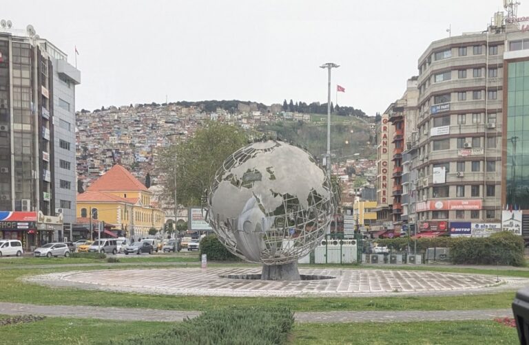 Smyrna today is Izmir, Turkey's third largest city. The old acropolis is atop Mt. Pagus where the flag can be seen.